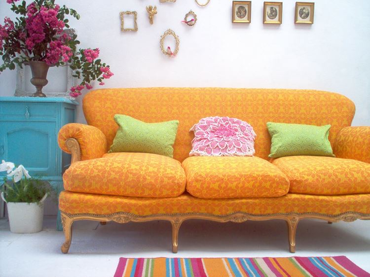 Оранжевый диван в интерьере: жёлто-оранжевый диван с принтом и подушками