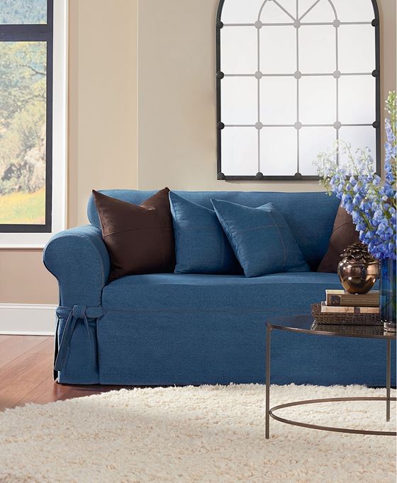 Джинсовый диван - коричневые и синие подушки и бежевые стены с пушистым ковром